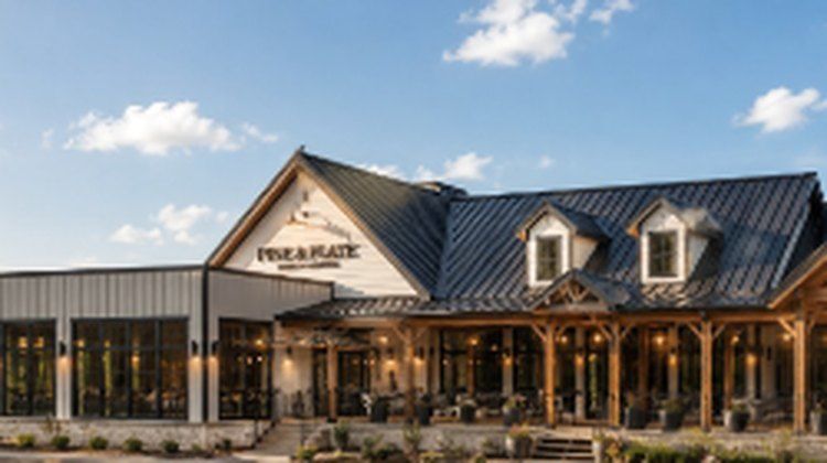 Finished restaurant with timber porch and metal roof, lit at dusk